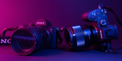 black nikon dslr camera on blue surface